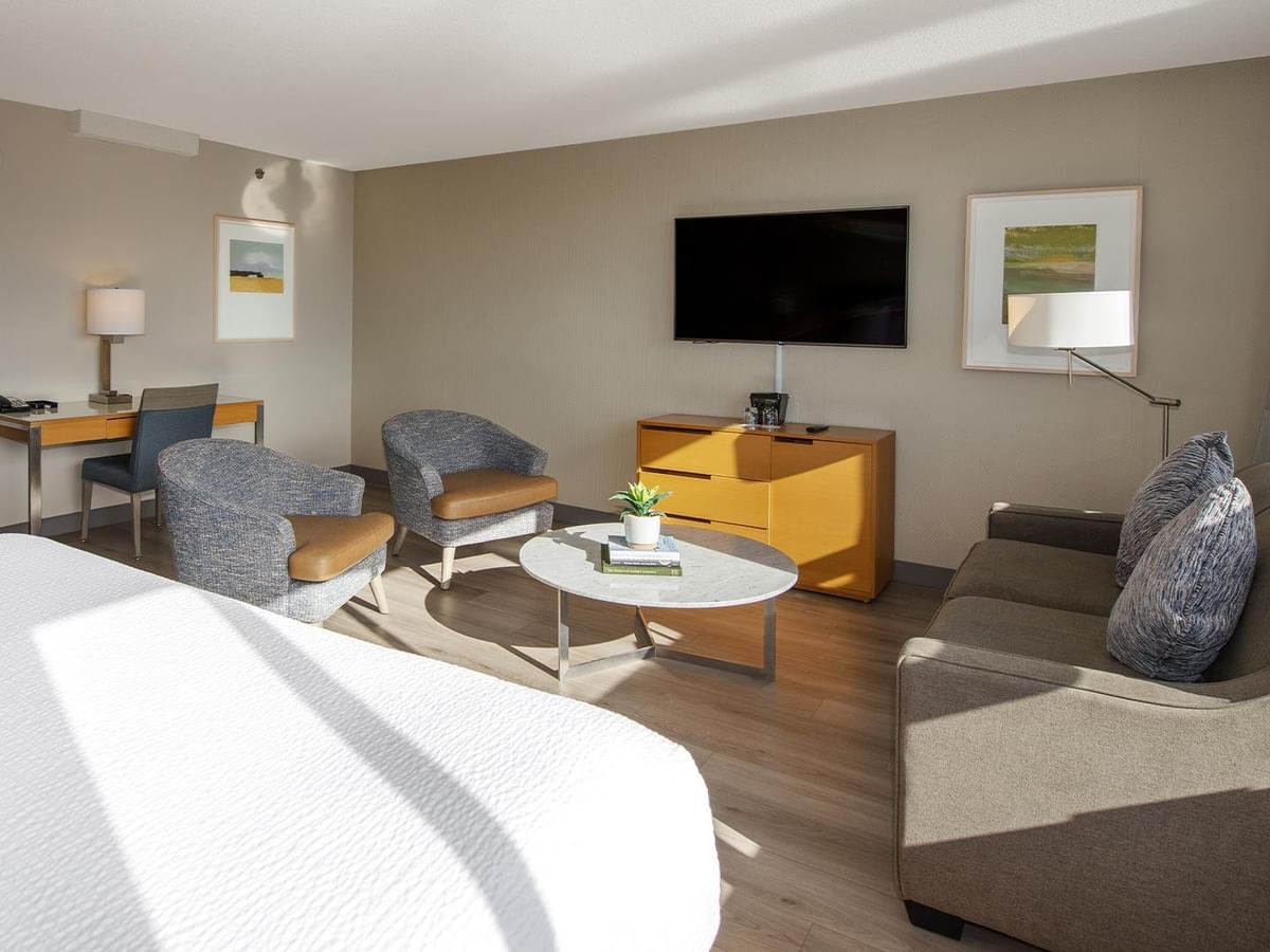 Elegant hotel room with a king bed and sofa bed