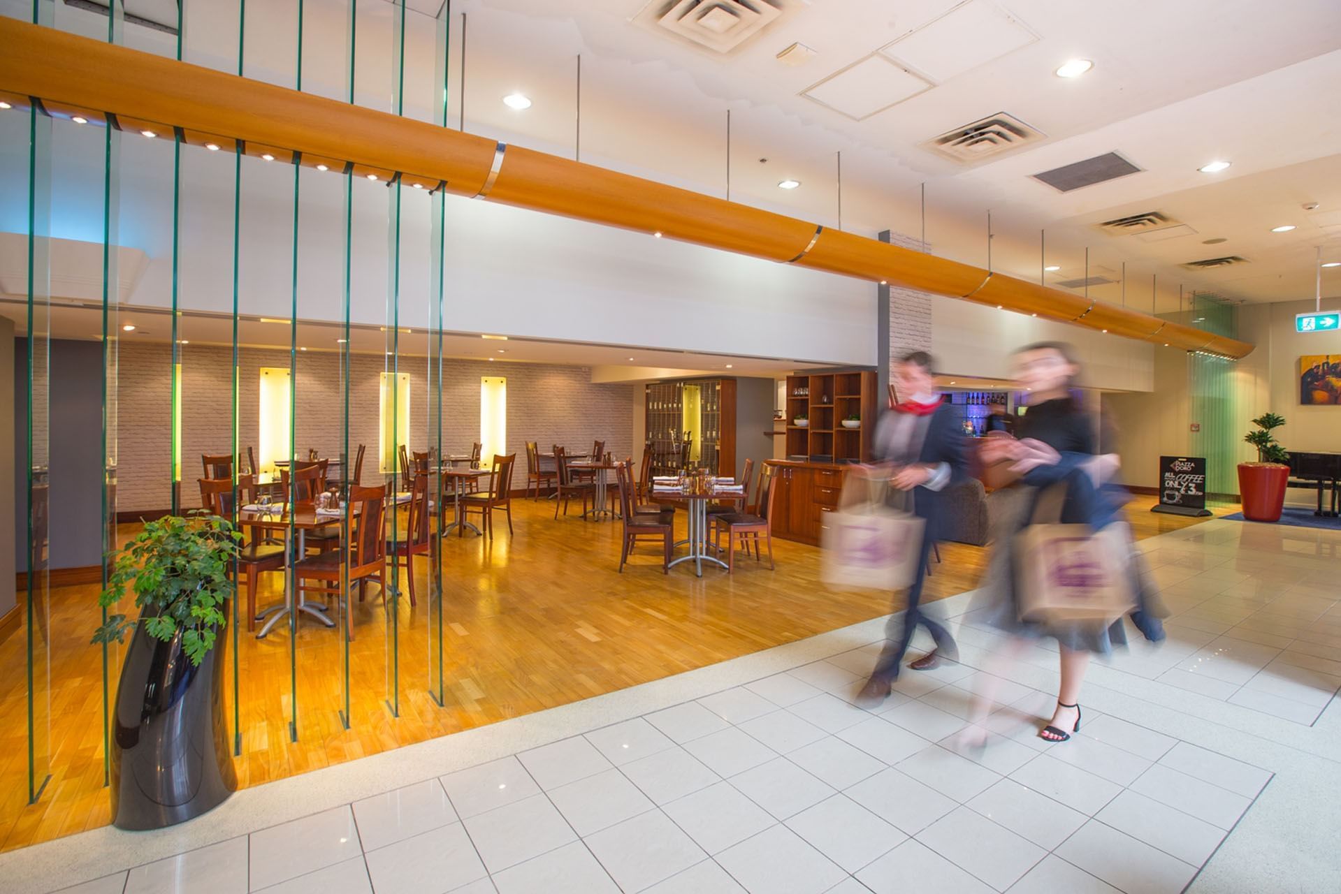 Guests passing by the elegant lobby area at James Cook Hotel Grand Chancellor