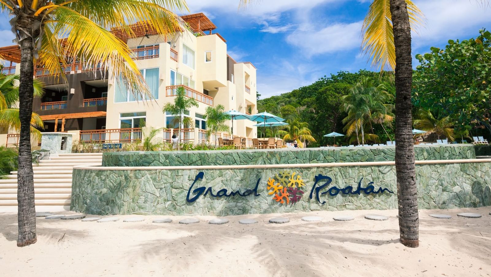 hotel on the beach with grand roatan logo