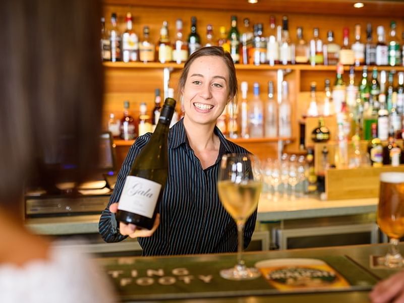 A bartender serving wine at East Coast Wine in Freycinet Lodge