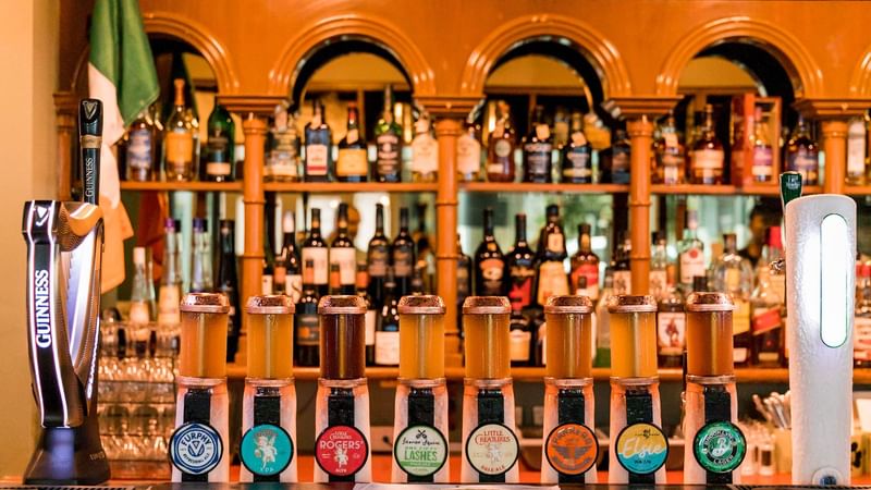 This image shows 10 of Fenians beer and cider taps, including a large Guinness tap.