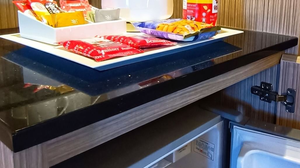 Premier Twin Room refreshment area with kettle, snacks on the counter, and mini-fridge below at Sunway Hotel Seberang Jaya