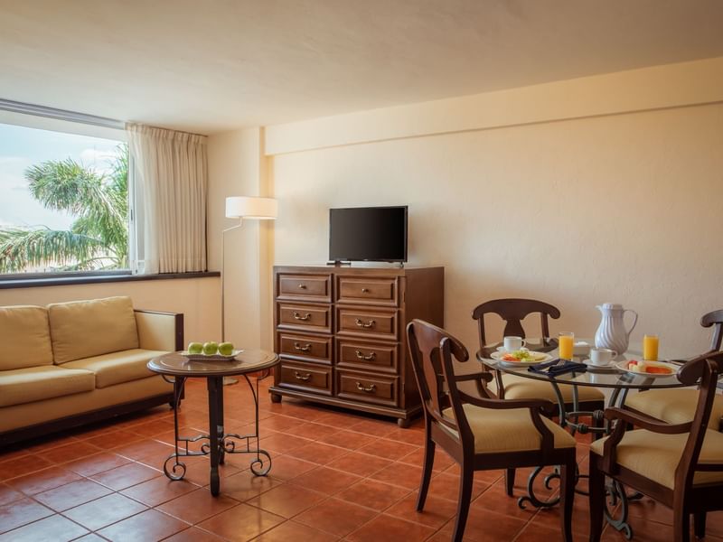 Living area with a TV in Master Suite at Gamma Hotels