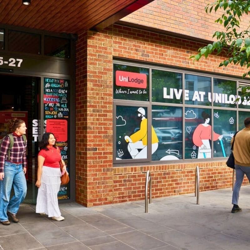 People walking outside the entrance of the UniLodge Royal Melbourne.