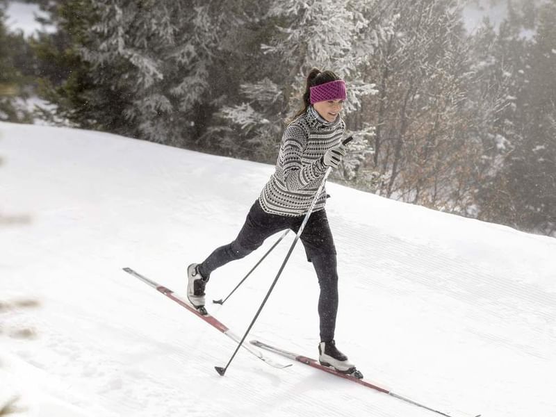 A girl doing cross-country skiing near Falkensteiner Hotels