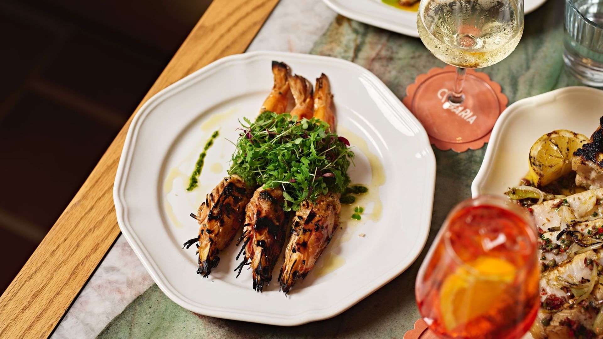 Cibaria Manly at Elysium Manly, featuring grilled prawns & cocktails under warm light, an elegant Italian restaurant in Manly