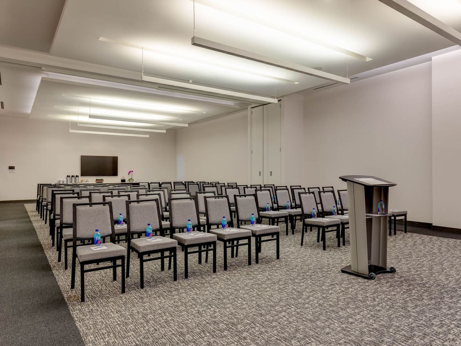 Spacious Riverdale Park with rows of chairs and a podium at Hotel X Toronto