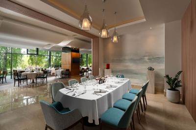 Restaurant Blue Dolphin interior with tables set for dining, featuring large glass windows at Ana Hotels Europa Eforie Nord
