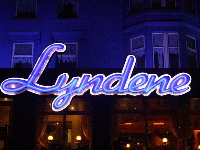 Exterior view of the Lyndene Hotel at night