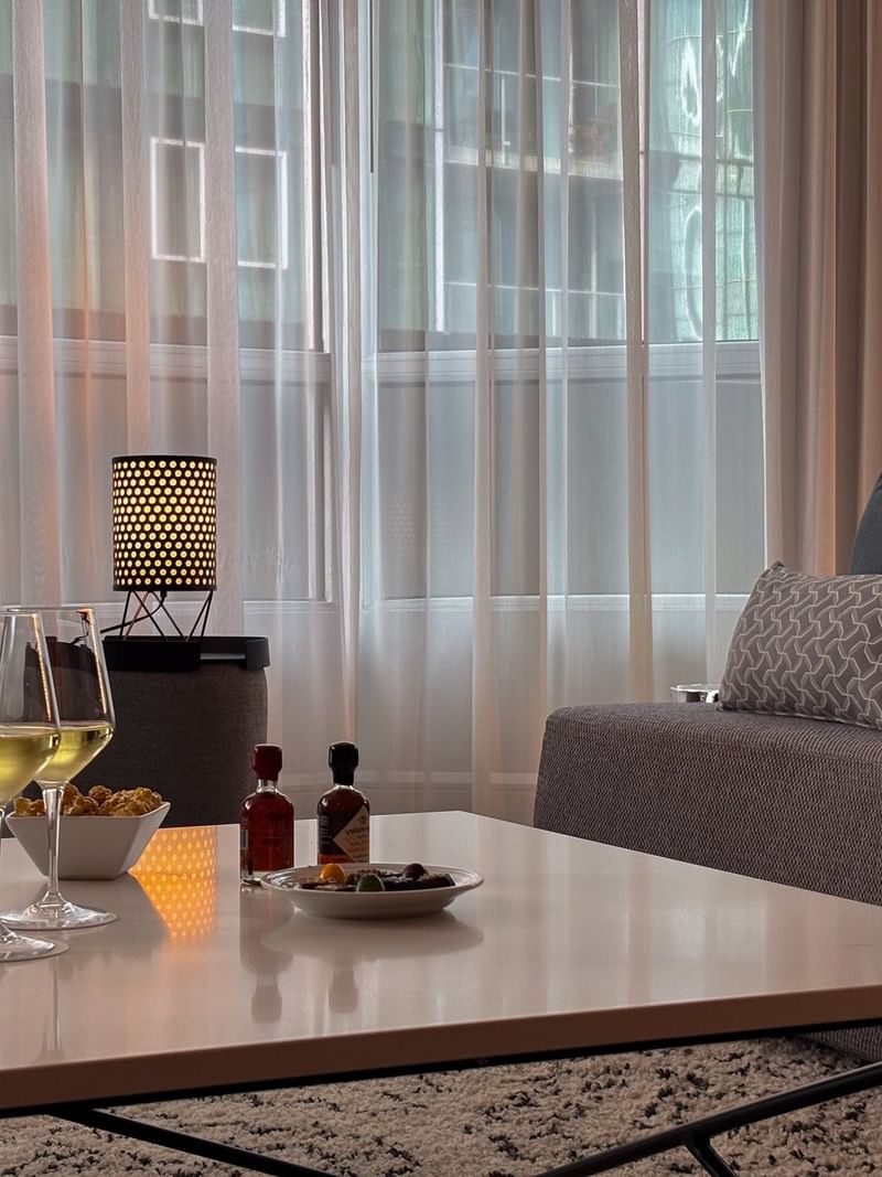 Cozy living area with wine and snacks in Penthouse Sainte-Catherine at Warwick Le Crystal Montreal.