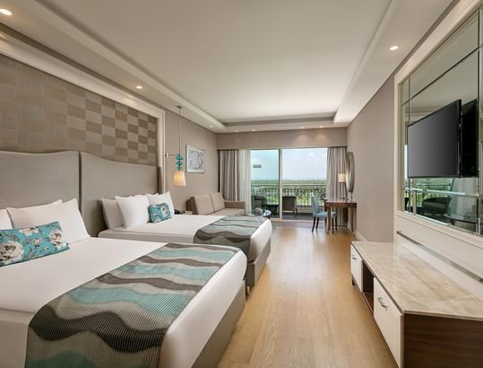 TV & work desk facing the beds in Superior Room with wooden floors at Titanic Deluxe Golf Belek