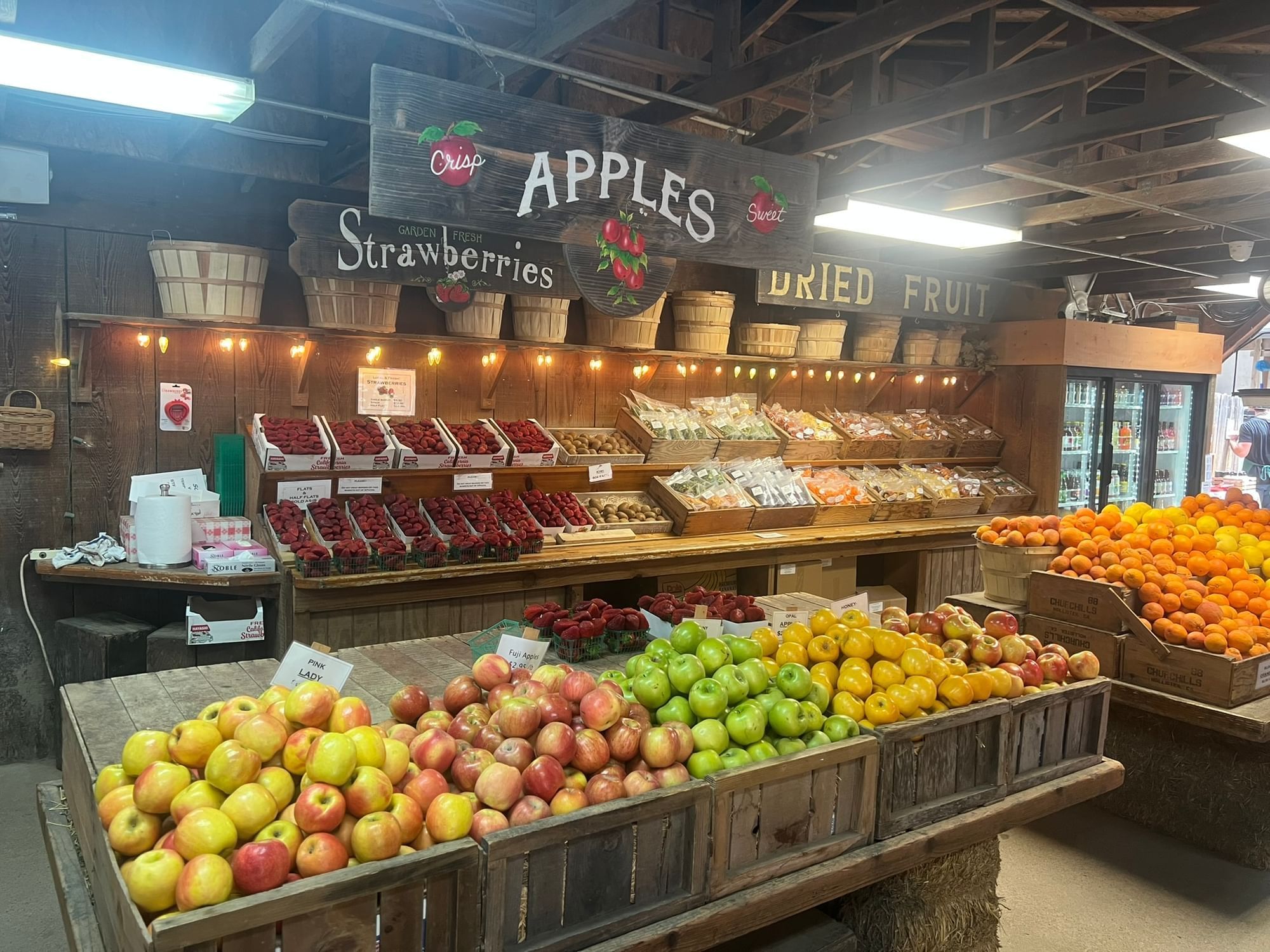 Avila Valley Barn interior with various fruits in wooden crates