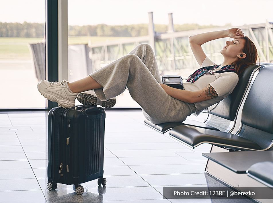 woman waits for plane boarding in airport