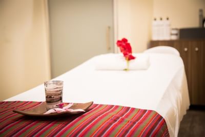 spa room with candles and flower