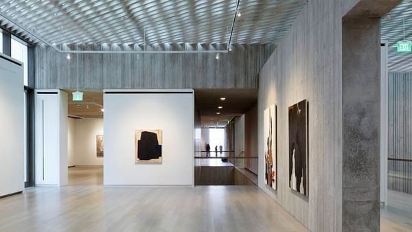 Modern art on wood walls by a polished floor under a lattice ceiling in Clyfford Still Museum near Warwick Denver