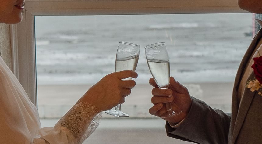 Wedding couple clinking glasses at The Imperial Hotel Blackpool