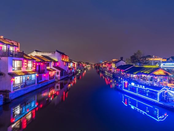 Exterior view of the Qingming Bridge with lights at night near Grand Park Wuxi