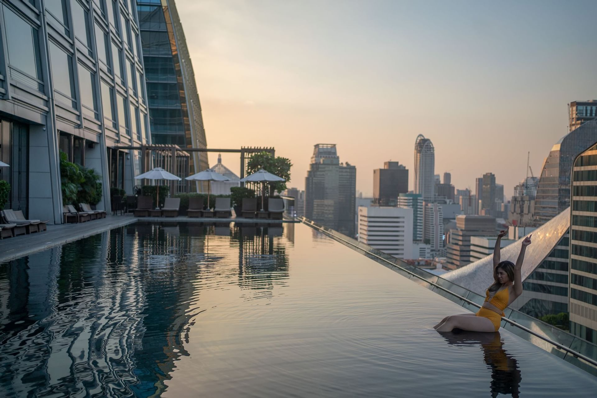 A girl in the rooftop swimming pool at Okura Prestige Bangkok