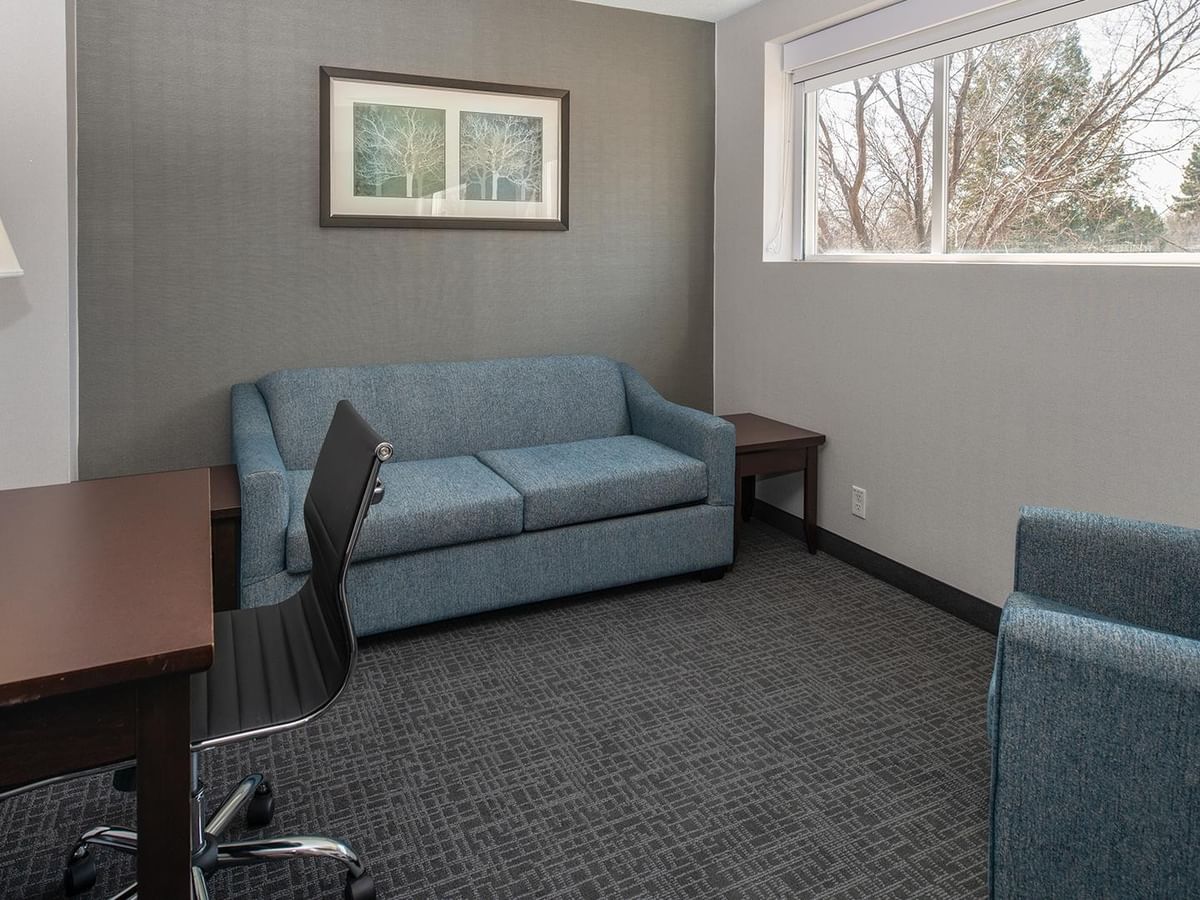 Comfortable seating and workspace in a hotel suite.