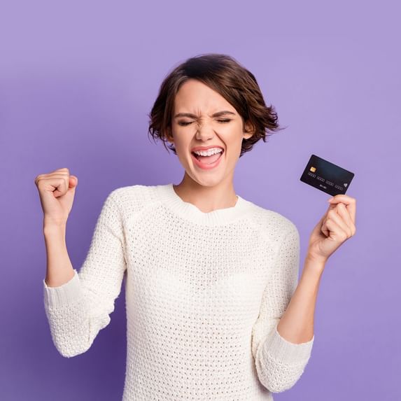 A girl holding a credit card