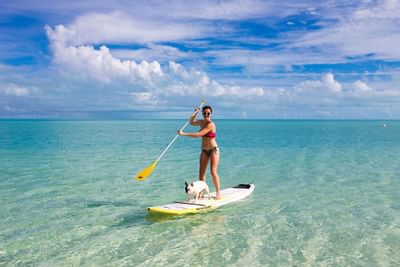 Lady paddle boarding at the sea near Somerset On Grace Bay