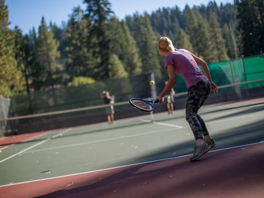 A woman playing tennis at Granlibakken Tahoe