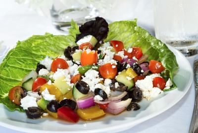 A salad with black olive served in a restaurant at Windsong Resort On The Reef