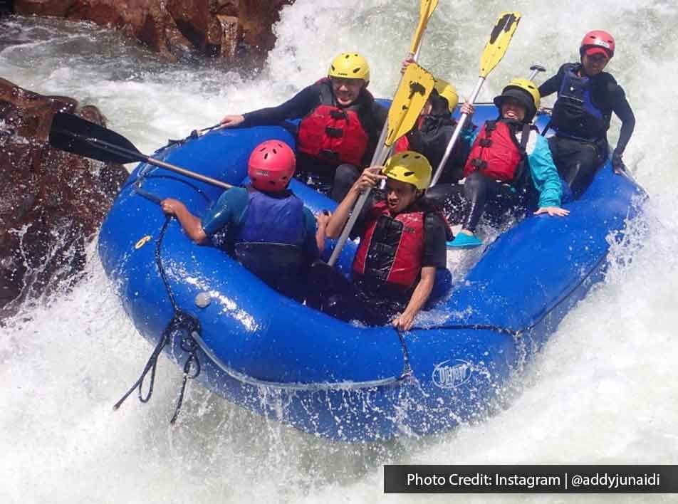 adventurous friends navigating wild rapids on rafts - Lexis MY