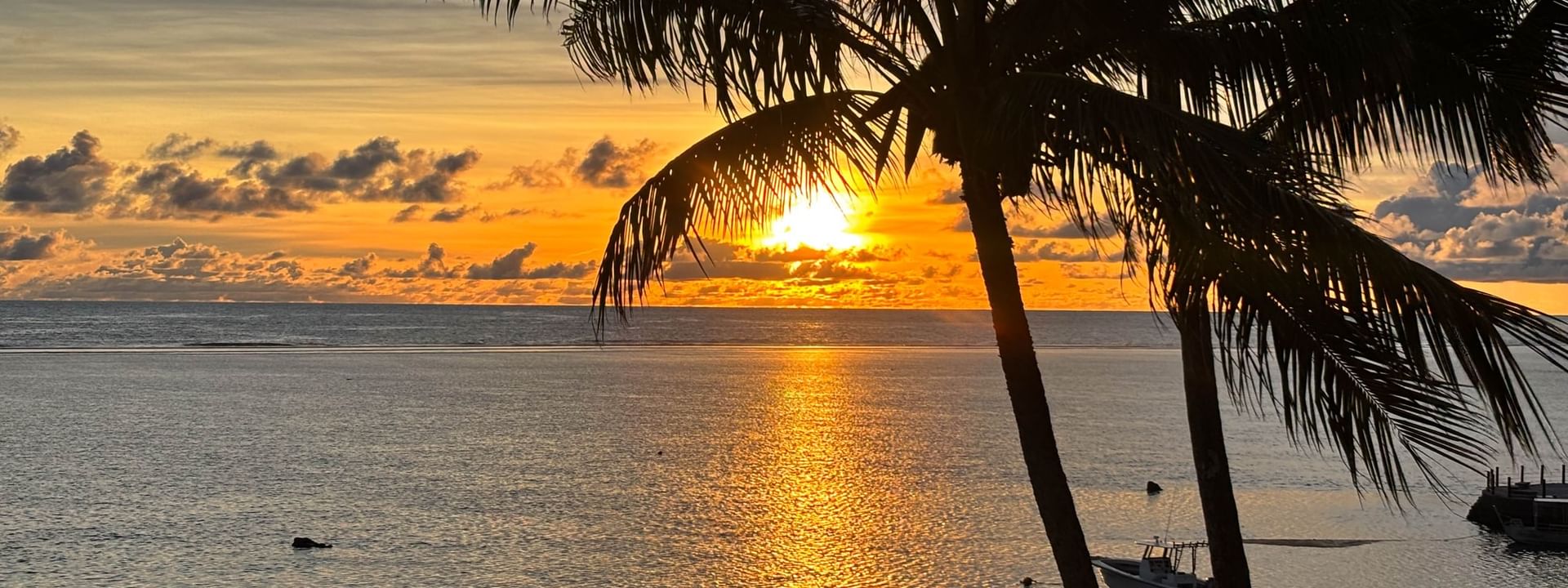 Sunset over the ocean with palm trees at the Sunset Terrace Bar, Warwick Fiji Resort and Spa, Korolevu