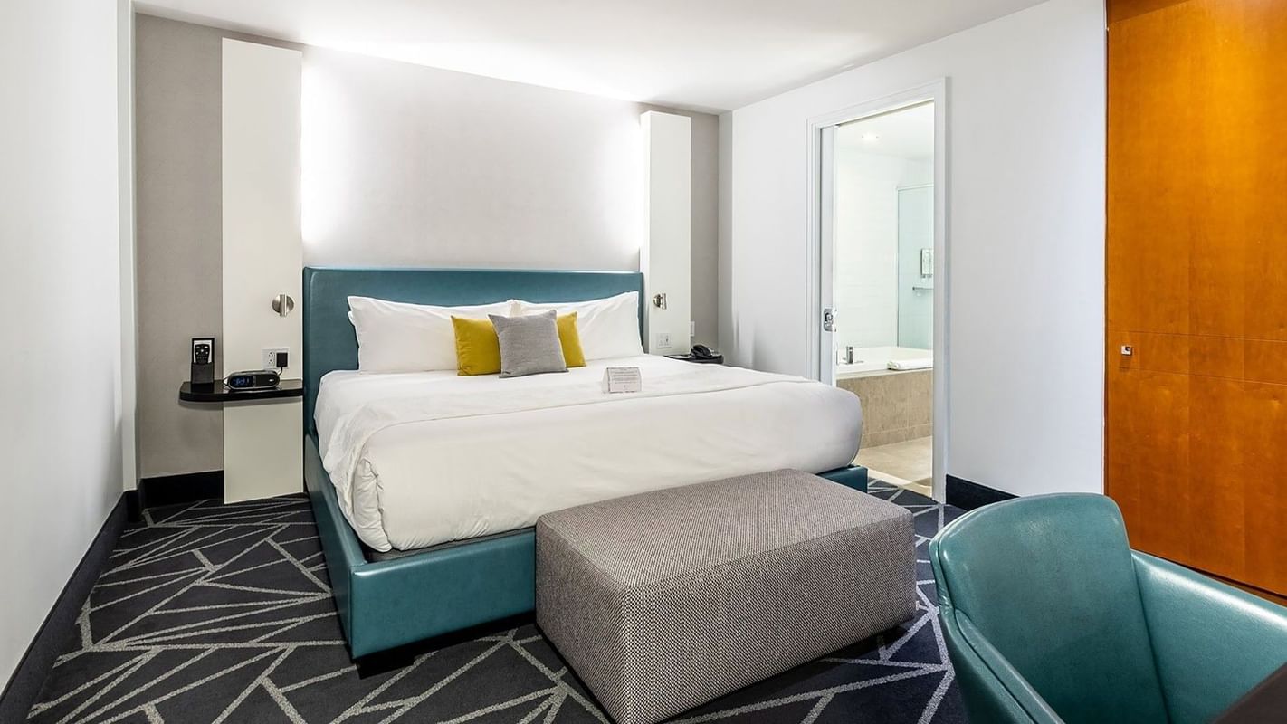 Penthouse Crescent featuring a teal leather bed and work area at Warwick Le Crystal Montreal