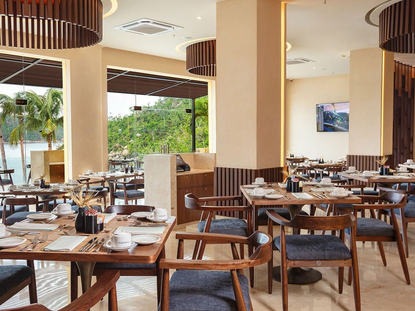 La Huerta restaurant dining area with wooden tables and ocean views at Camino Real Acapulco Diamante