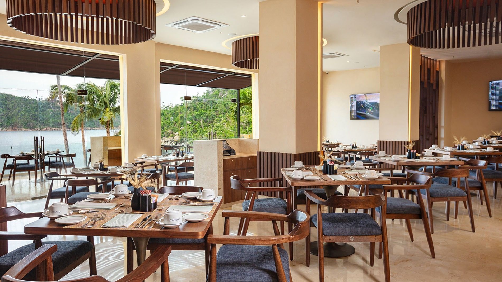 La Huerta restaurant dining area with wooden tables and ocean views at Camino Real Acapulco Diamante