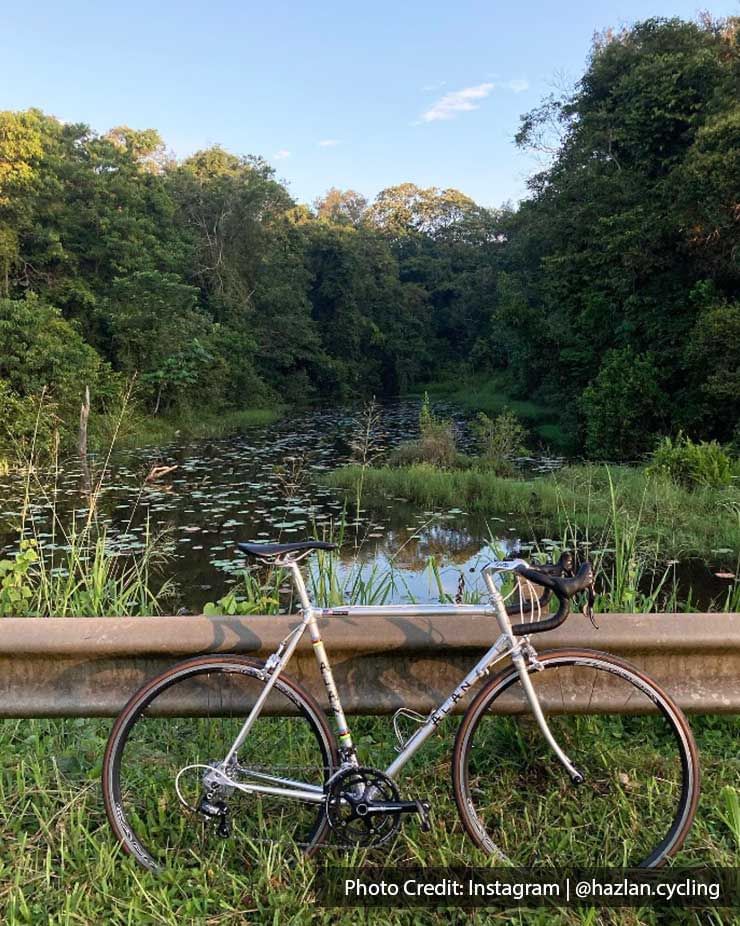 a bicycle against a rail by the side of the road