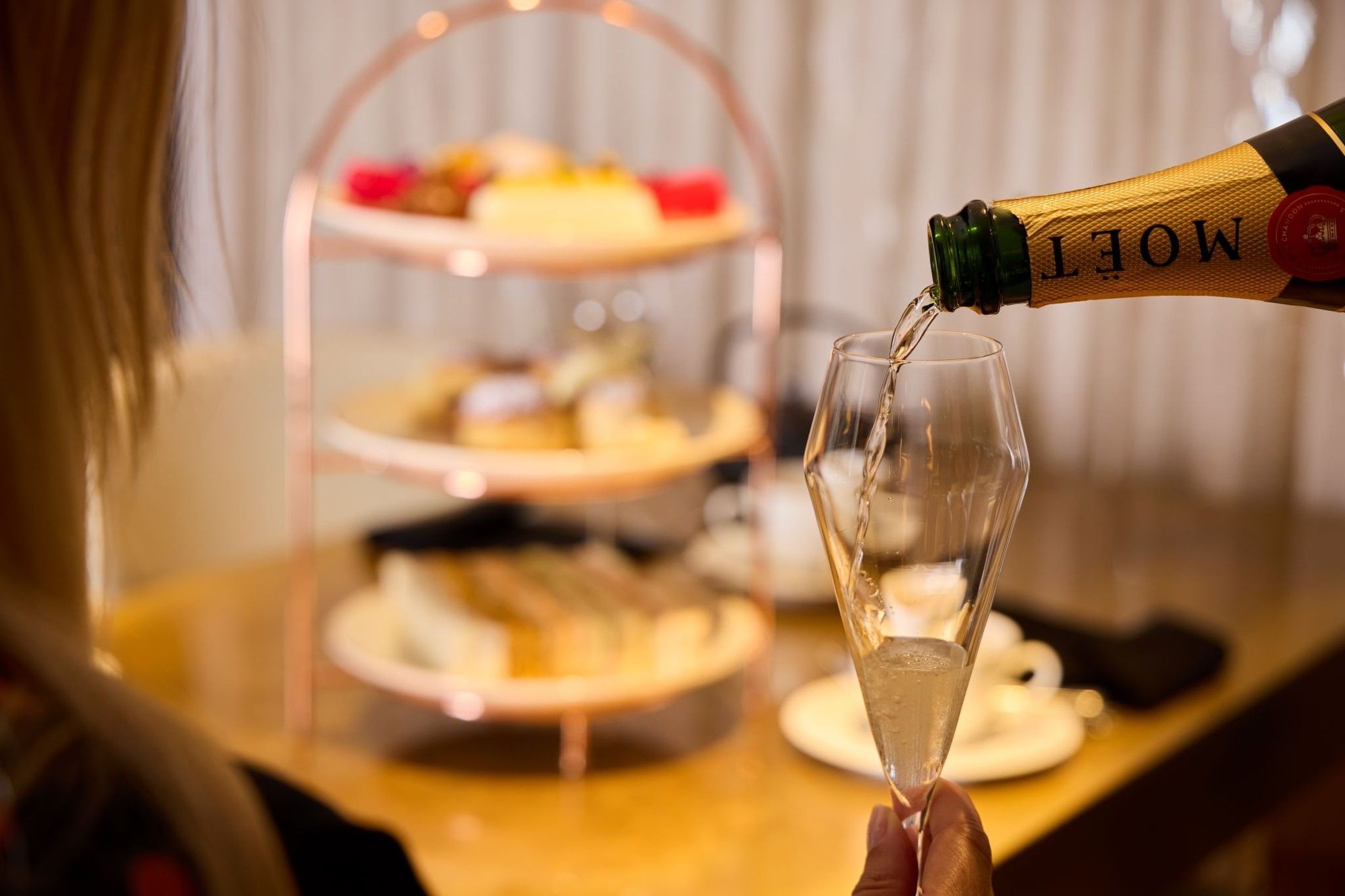 Moët champagne being poured for Champagne Afternoon Tea in May Fair Kitchen