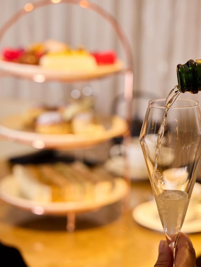 Moët champagne being poured for Champagne Afternoon Tea in May Fair Kitchen