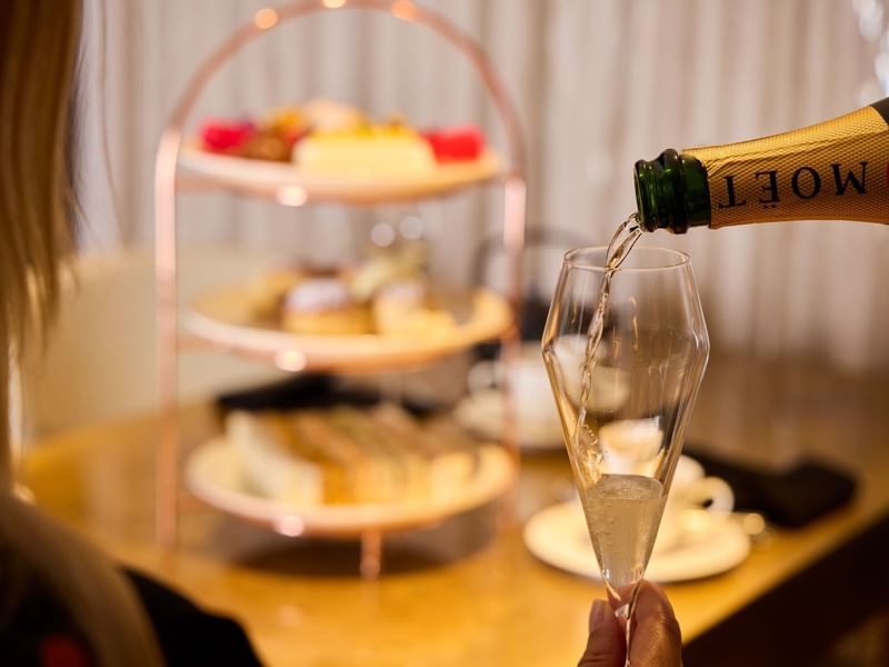Moët champagne being poured for Champagne Afternoon Tea in May Fair Kitchen