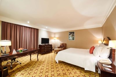 Premium Deluxe Room with a king size bed & a working desk at Eastin Grand Hotel Saigon