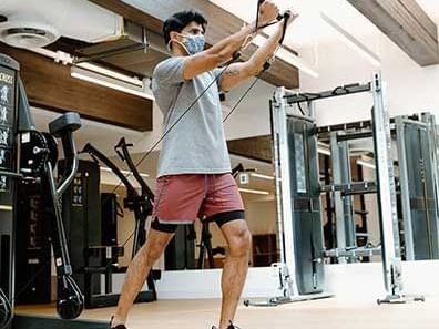 man and exercise equipment in fitness centre