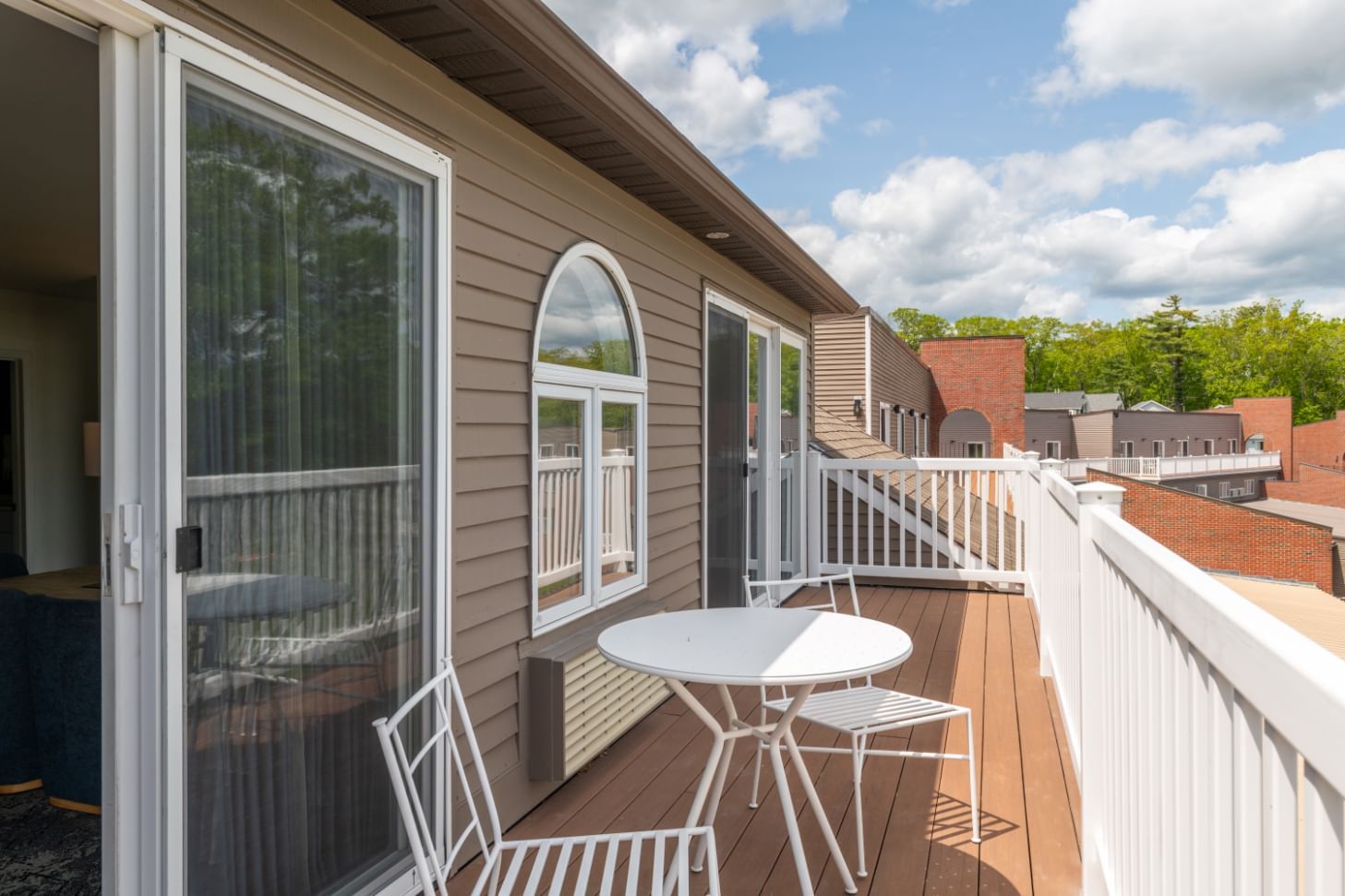 A balcony with a table and chairs