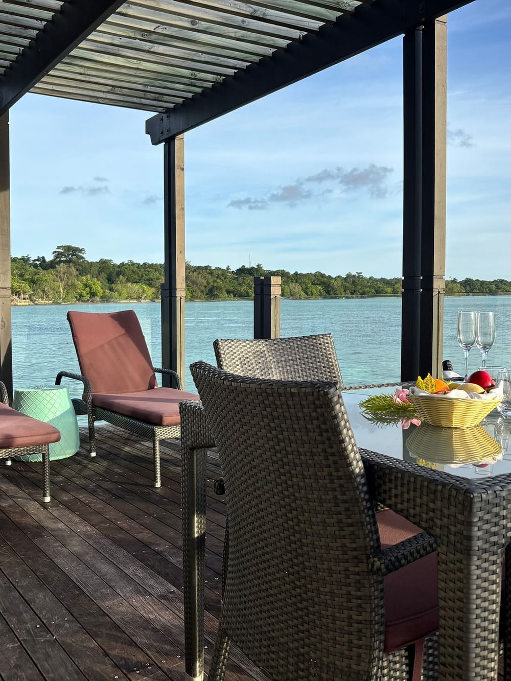 Outdoor dining area with sea view in Overwater Villa at Warwick Le Lagon - Vanuatu, Efate.