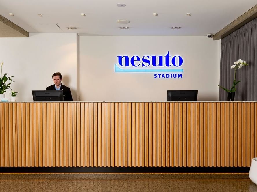 A receptionist in the 24-hour reception counter at Nesuto Stadium Hotel and Apartments