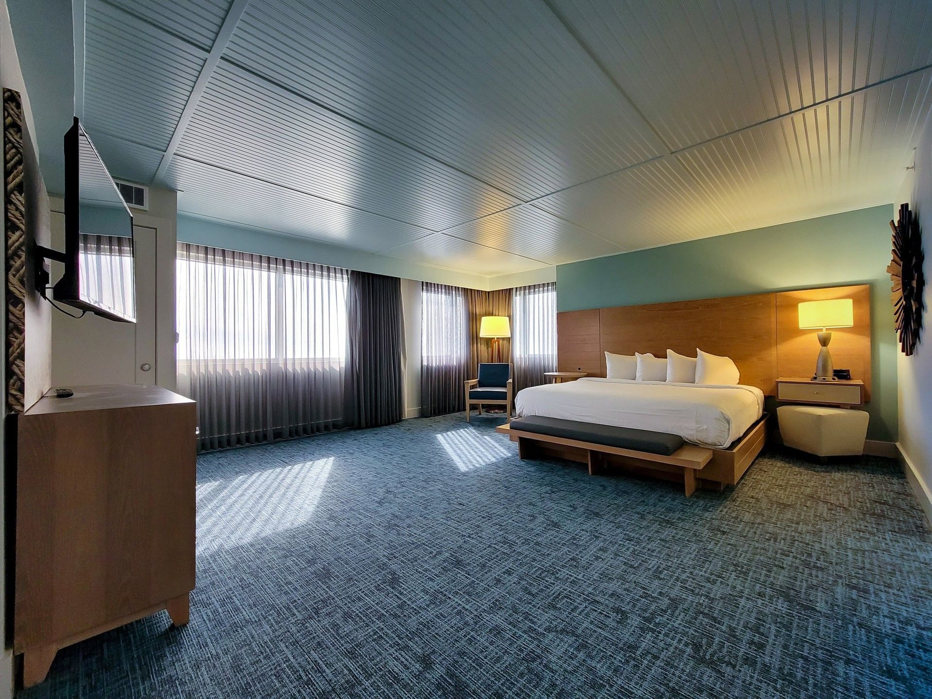King Corner Suite featuring a blue plank ceiling and ample floor space with rugs at Margaritaville Resort Biloxi