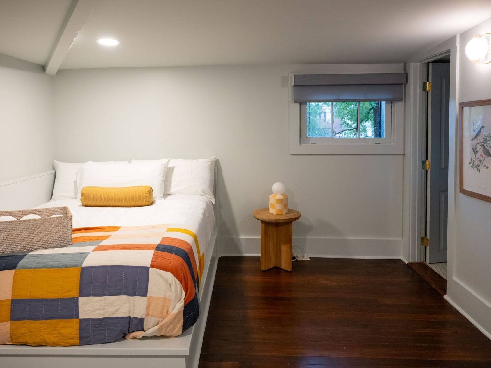 Wooden stool by the bed in the Classic Loft Queen room at The Ashbrook Hotel, featuring Frankfort Kentucky accomodations.
