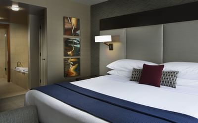Stylish and cozy Metropolitan Suite at The Paramount Hotel Seattle with a king-sized bed and contemporary art