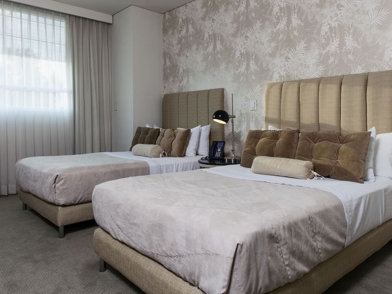 Two comfy beds in the Superior Room Double at Gamma Hotels