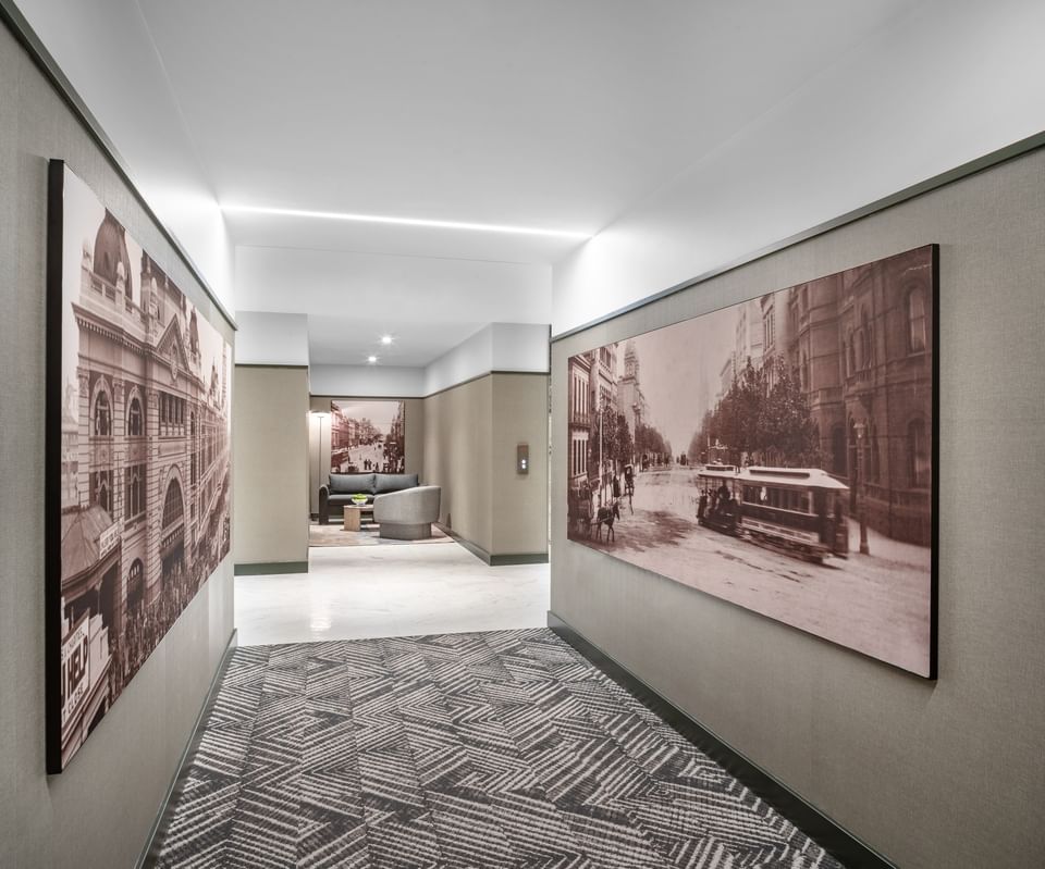 Modern hallway with vintage sepia photos of historical architecture on walls at Amora Herencia Riverwalk Melbourne