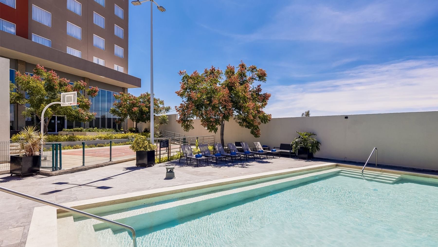 Pool with pool chairs at Fiesta Inn Suites Aeropuerto del Bajío Silao