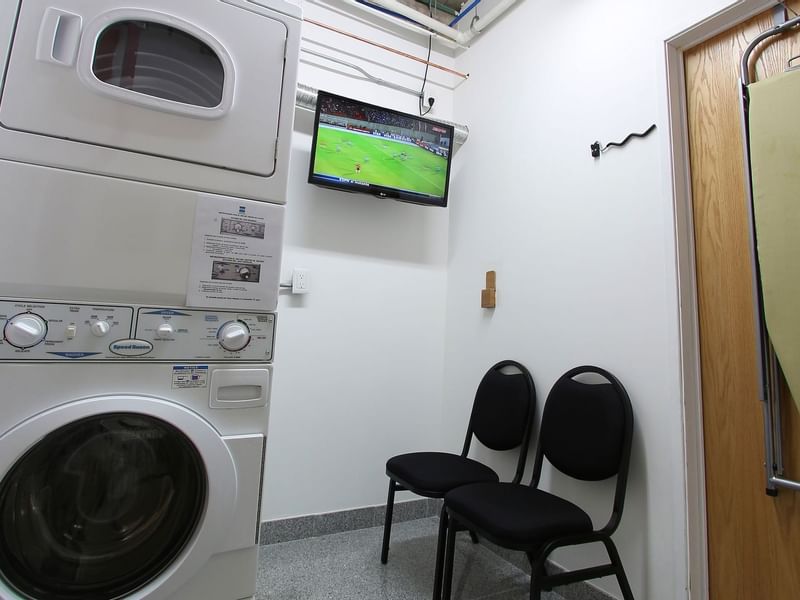 Washing machine, dryer and chairs in Laundry Room at One Hotels