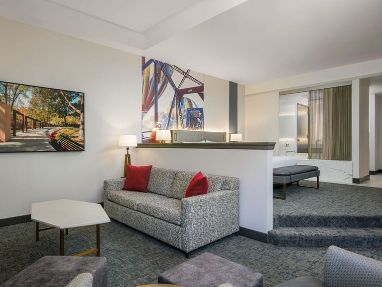 Spacious Longitude Suite with a bed and a cozy living area separated by a low wall and steps at Hotel 43 Boise