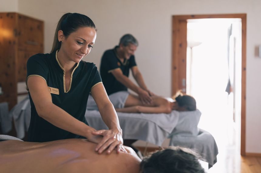 Close-up of ongoing body massages at a spa in Liebes Rot Flueh